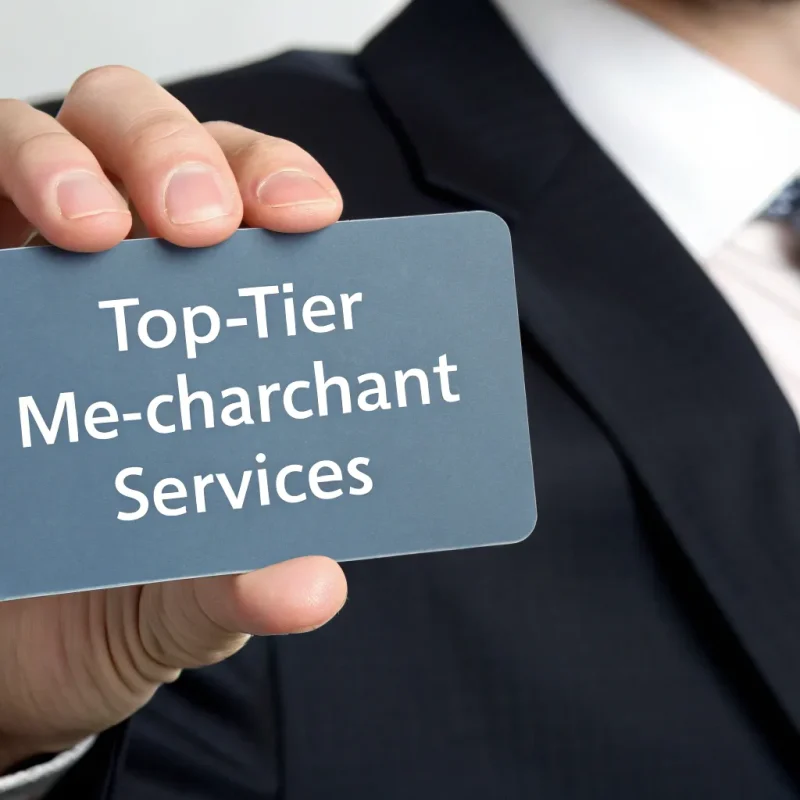 A business professional holding a card for top tier merchant services.